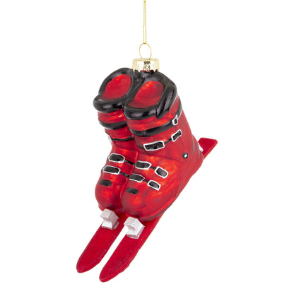 Glob de Crăciun decorativ cu design clăpari ski roșii, ideal pentru a adăuga culoare și personalitate bradului de sărbători. Perfect pentru iubitorii sporturilor de iarnă, acest ornament aduce un accent vibrant și modern în decorul festiv.