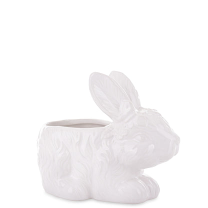 Ghiveci decorativ din ceramică albă cu design iepure, ideal pentru plante mici, suculente sau decor de Paște și primăvară. Este o piesă veselă și luminoasă care aduce un aer cald în orice spațiu. Perfect ca decor sau cadou sezonier pentru familie sau casă nouă.