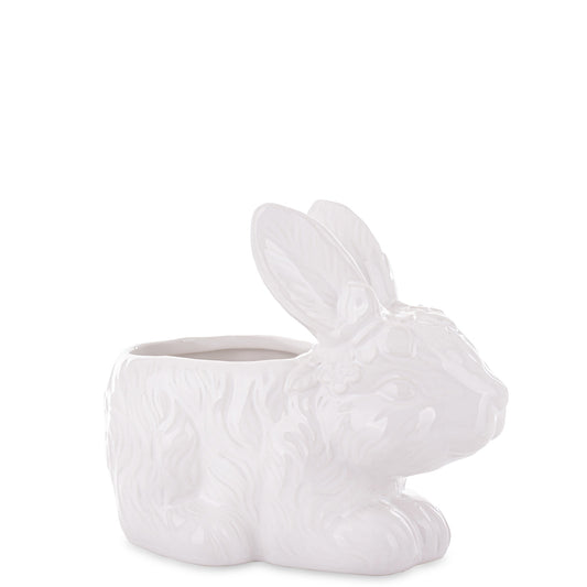Ghiveci decorativ din ceramică albă cu design iepure, ideal pentru plante mici, suculente sau decor de Paște și primăvară. Este o piesă veselă și luminoasă care aduce un aer cald în orice spațiu. Perfect ca decor sau cadou sezonier pentru familie sau casă nouă.